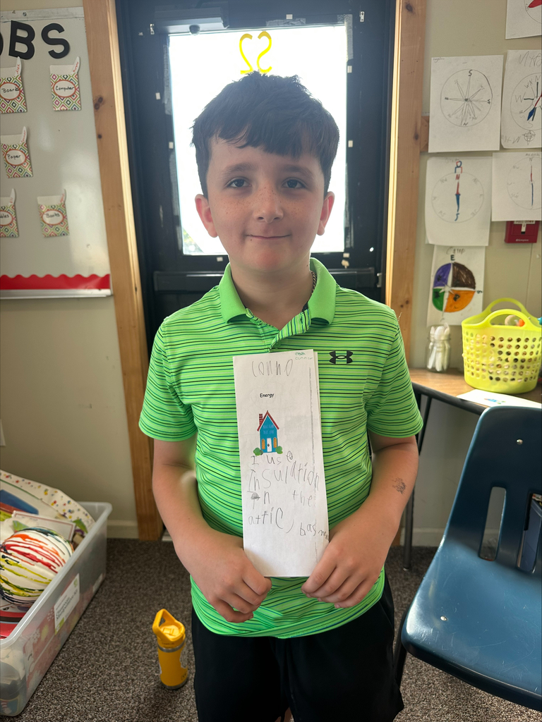 A student smiling with his energy project