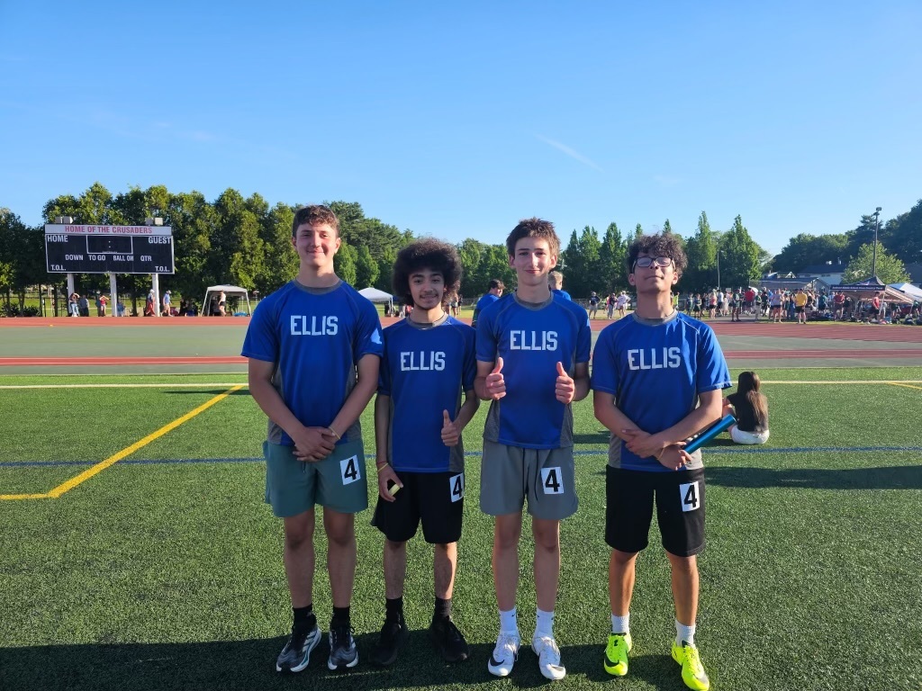 The boys' relay team posing for a photo