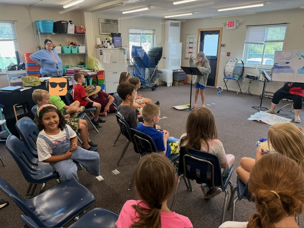 Students smiling while listening to the Duck! Rabbit! show.