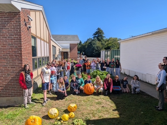 Our middle schoolers posing with their giant pumpkins!
