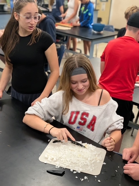 Students cutting up onions for salsa