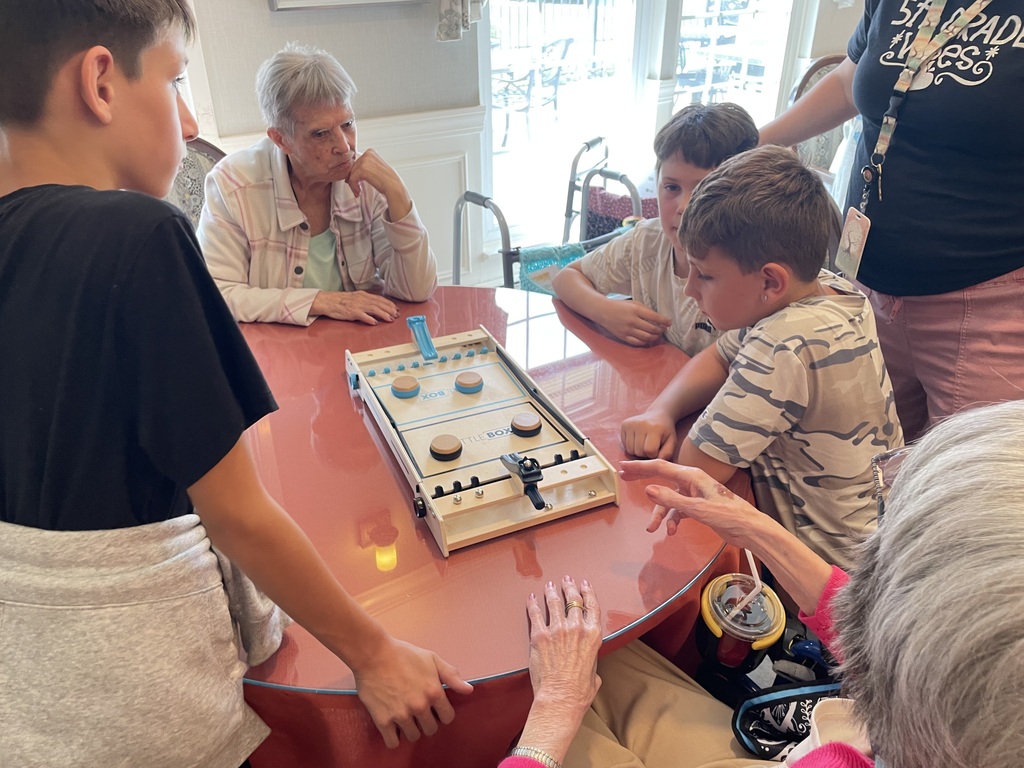 Fifth graders teaching residents a game