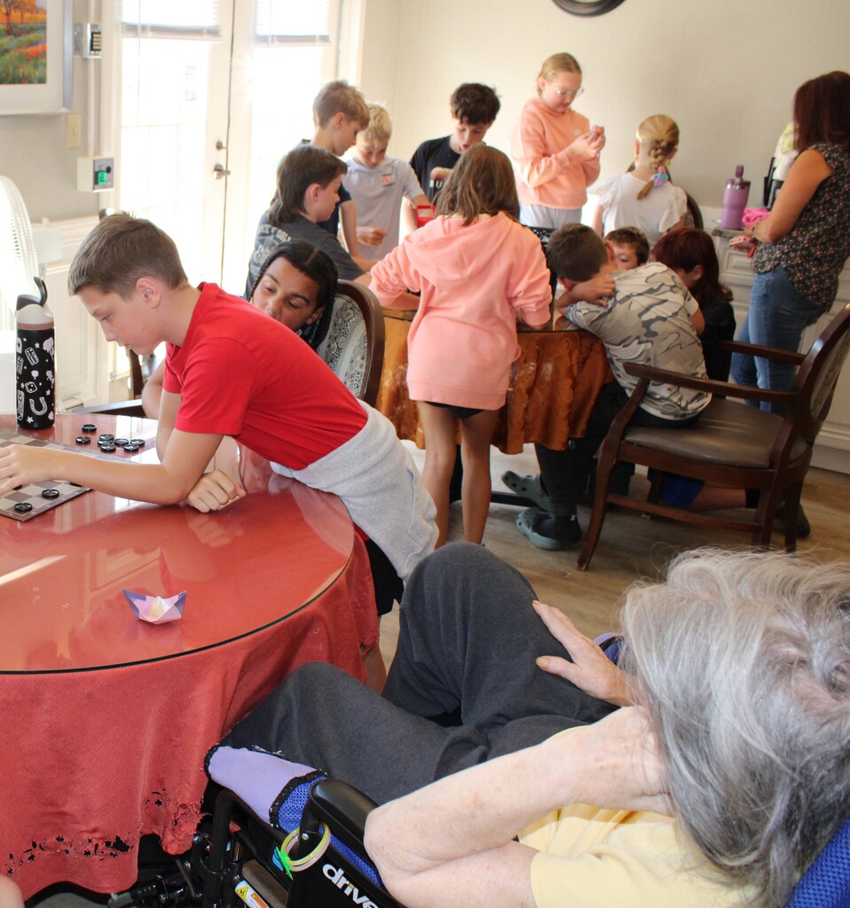 Fifth graders playing games with residents
