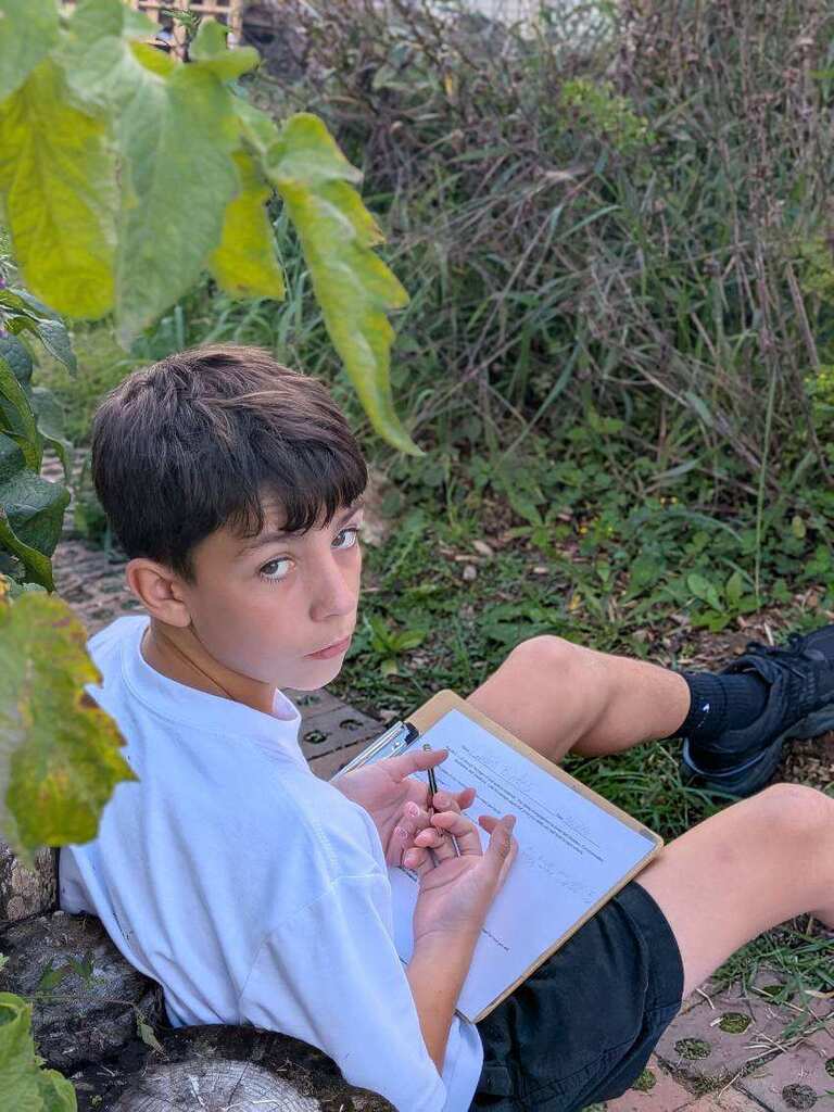 A student looking back at the camera while getting ready to write