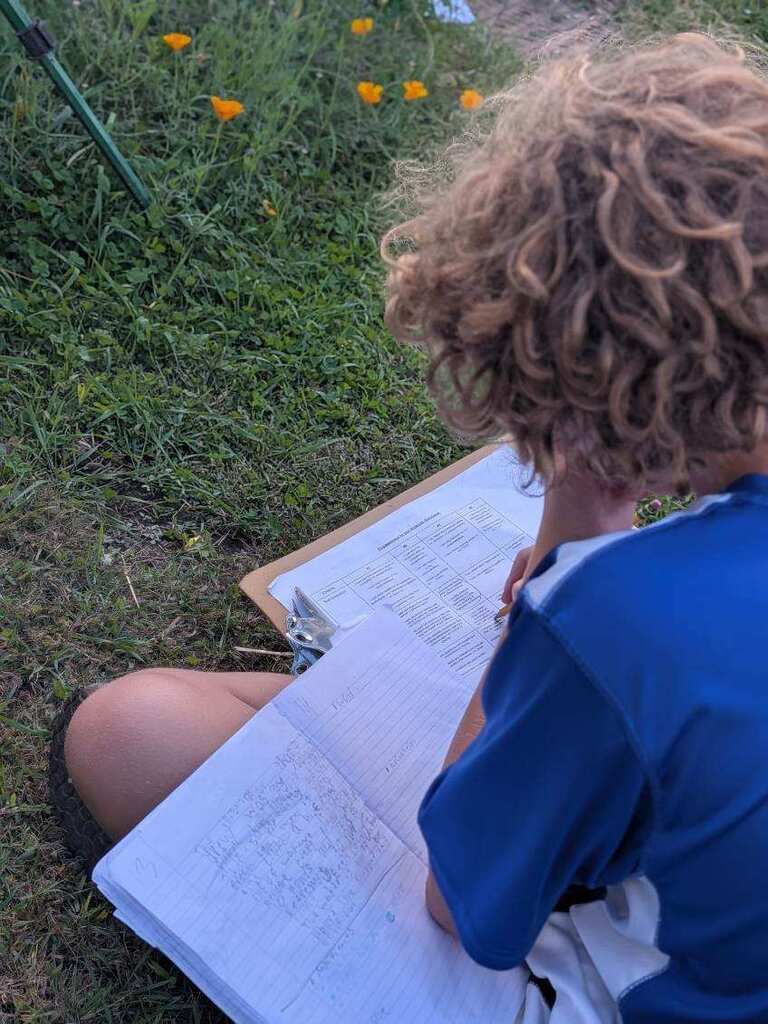 A student writing in his notebook