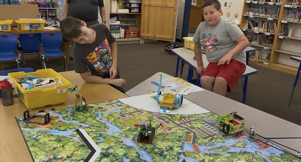 Two students coding their robot