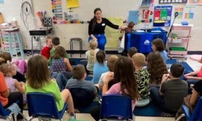 Mrs. Therrien leading students in a lesson with a puppet