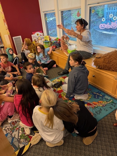 Ms. Cheryl teaching the students about the library.
