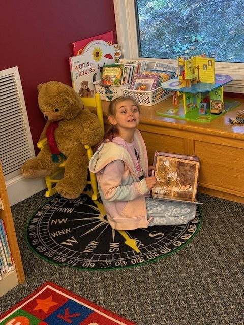 A student smiling with the book she selected