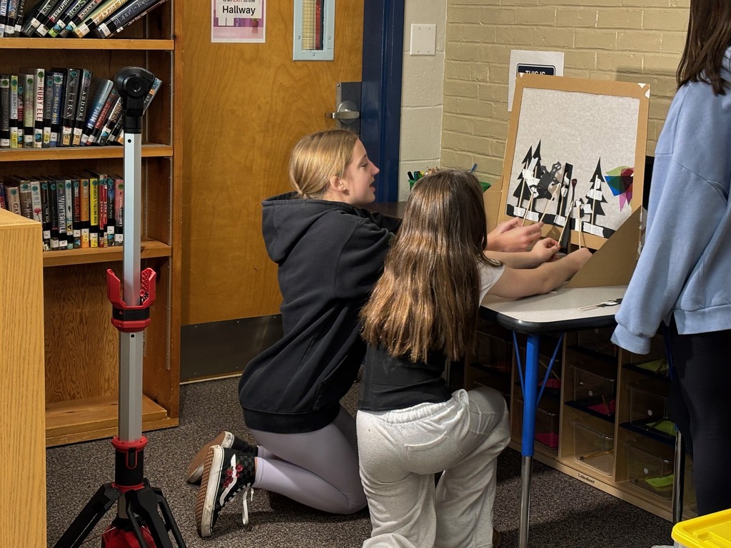 Students using shadow puppets to make their video.