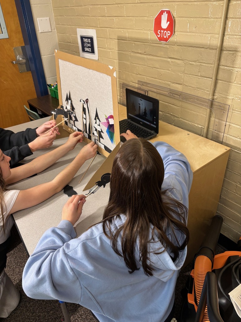 Students using shadow puppets to make their video.