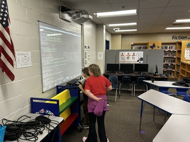 Students working on code together.