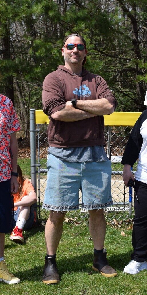 Mr. Asbell standing with his arms crossed.