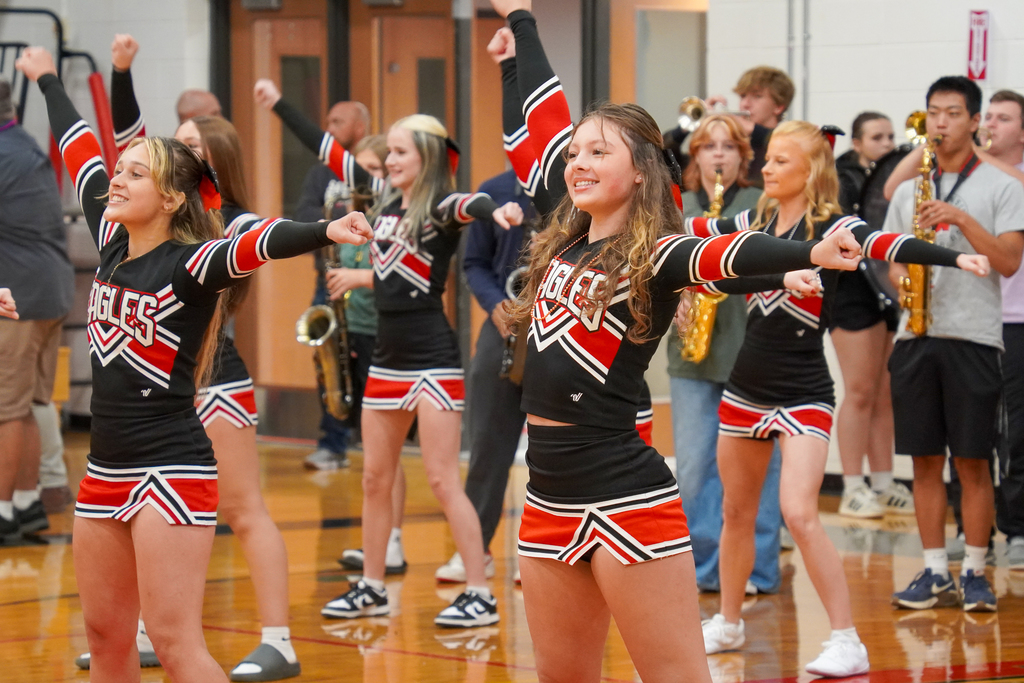 Cheer team performs during school fight song.