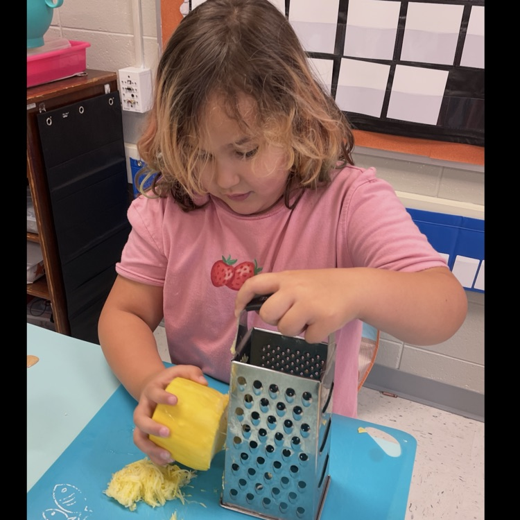 Learning how to use a grater!