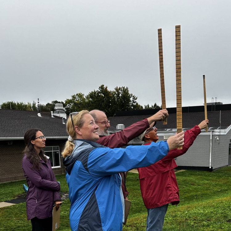 Measuring the board feet of a white pine in Pine Town on the playground. 