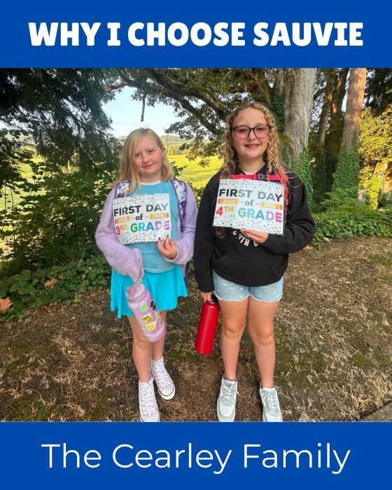 Cearley girls posing with first day of school sgns
