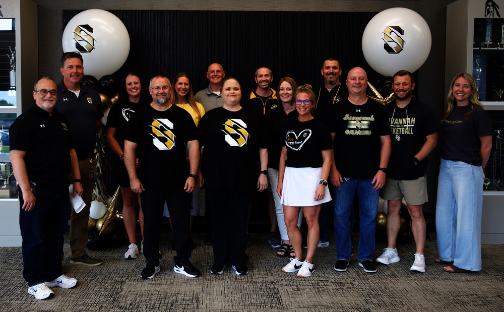 Group photo of Savannah R3 administrators and district leaders standing together in front of a black, white, and gold balloon display during the district’s End-of-Year Celebration.
