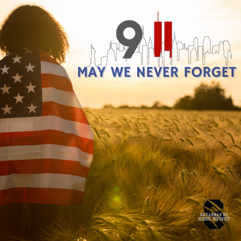Person wrapped in an American flag stands in a golden field at sunset. Overlay text reads “9/11 May We Never Forget” with a city skyline and the Savannah R3 School District logo.