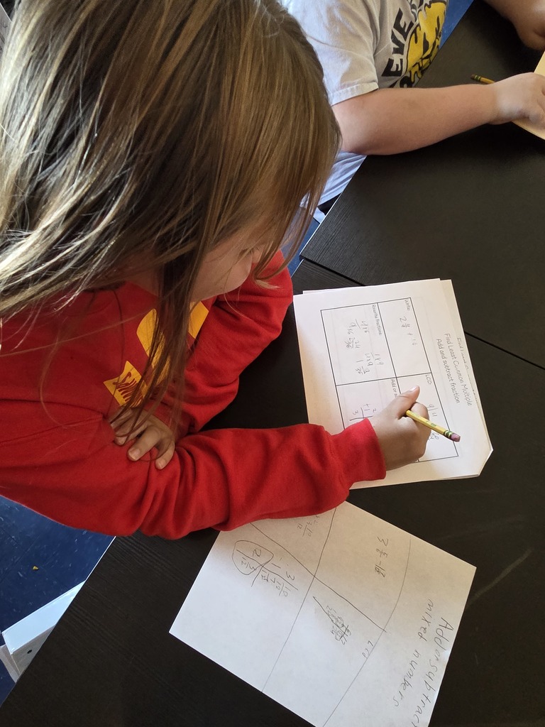 A young girl completes a math worksheet 