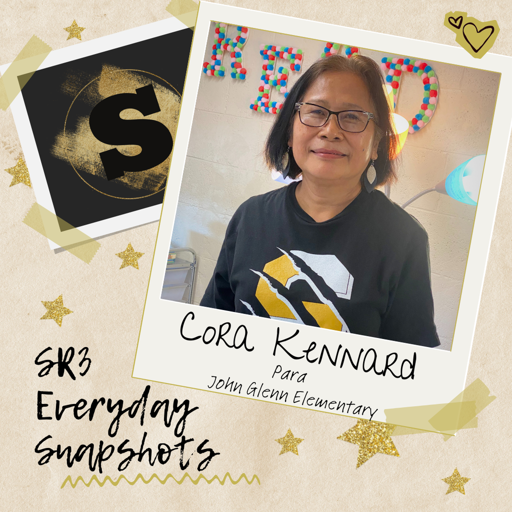 Paraeducator Cora Kennard smiles while standing in a John Glenn Elementary classroom decorated with the word ‘READ.