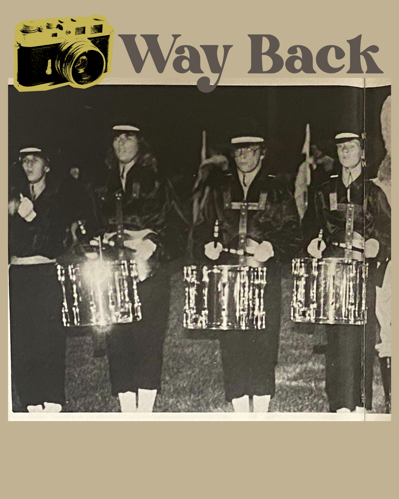 "Vintage black-and-white photo of a high-school marching band drumline standing in uniform with snare drums. A retro camera icon and the words ‘Way Back’ appear at the top."