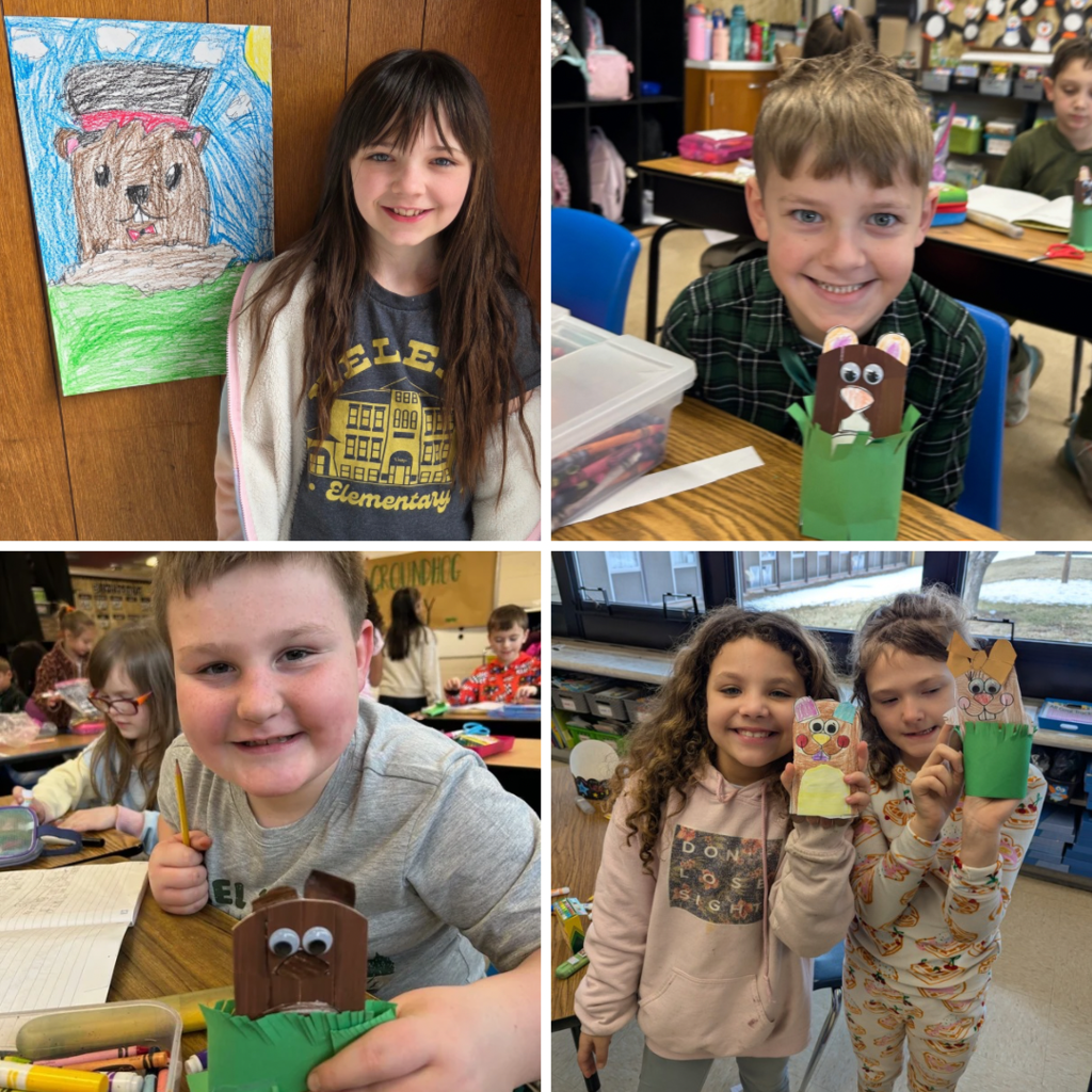 Elementary students smiling and posing with their completed groundhog crafts at classroom tables.