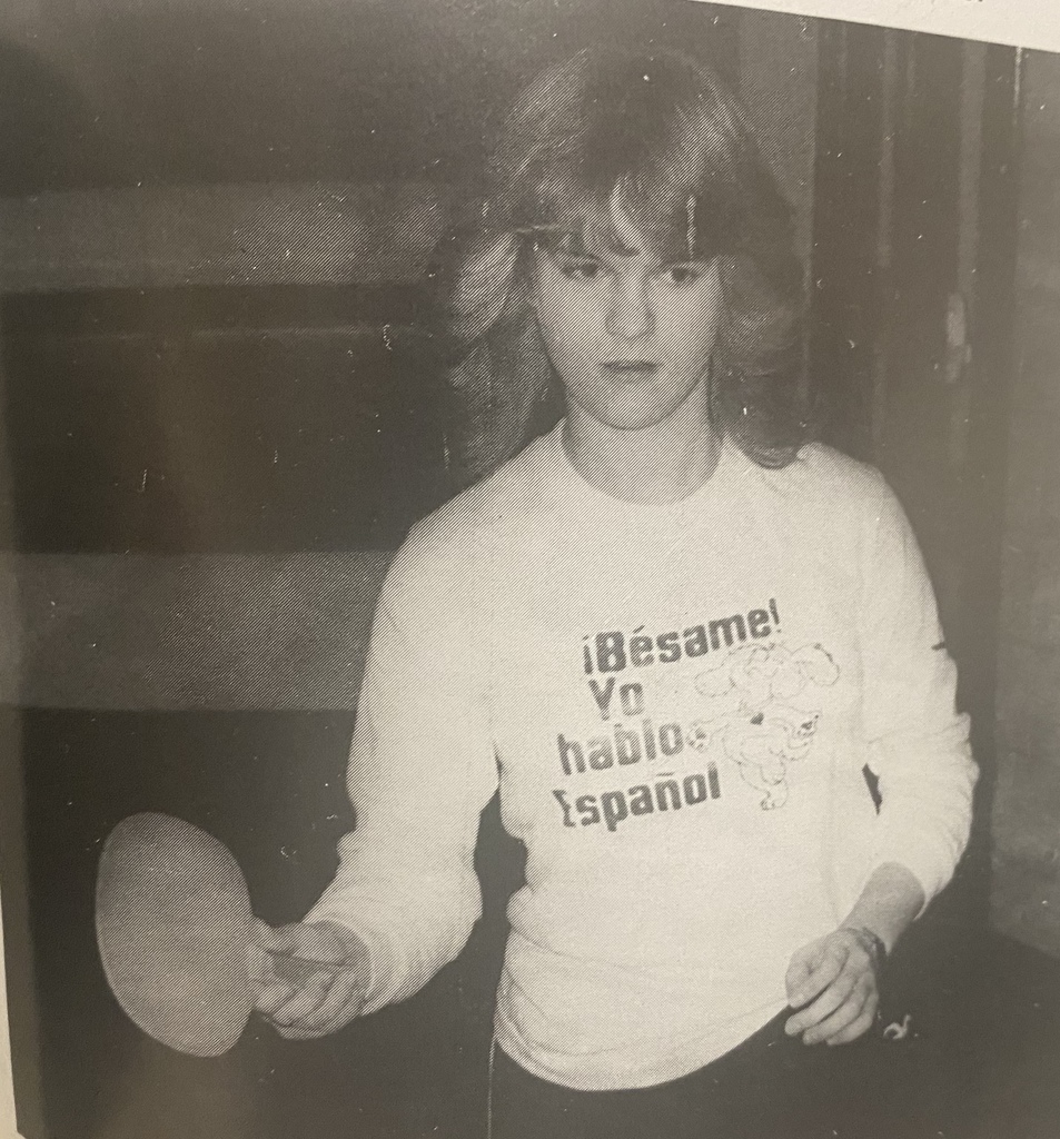 Picture from the 1984 year book of a student playing ping pong. 