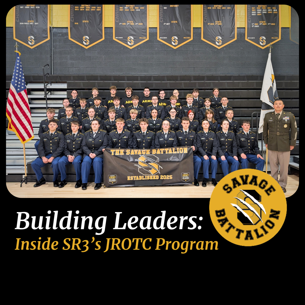 Savannah High School JROTC cadets in uniform pose in gym with flags and instructor Sgt. Barry Adwell.
