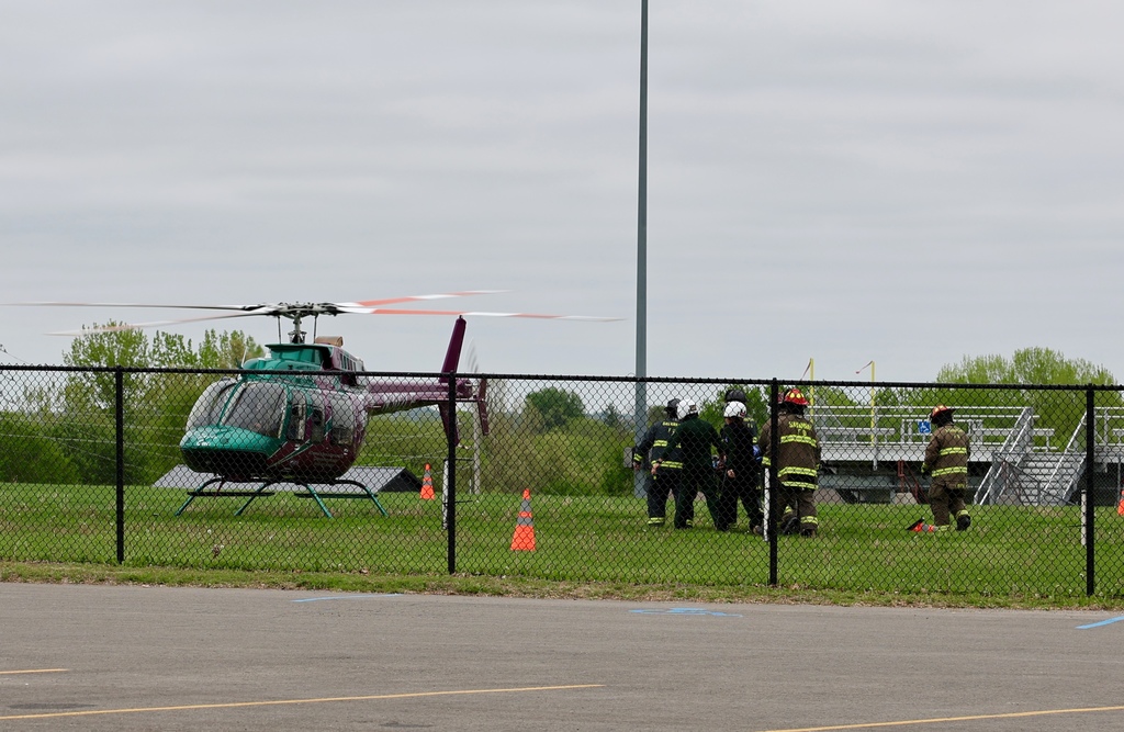 Medical helicopter lands near the school as part of the Docudrama emergency response simulation.
