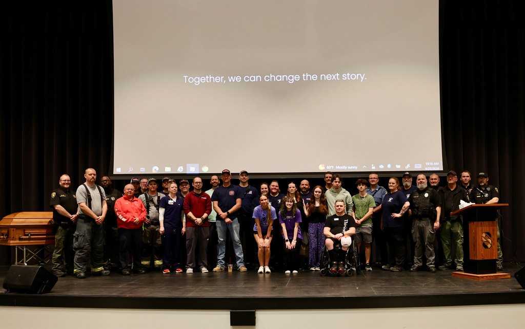 Group of first responders, staff, and students on stage during Savannah High School’s Docudrama presentation.