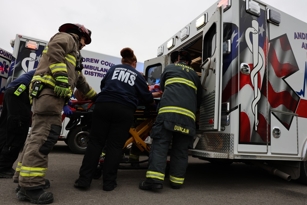 Emergency responders load a patient into an ambulance during the Docudrama simulation.