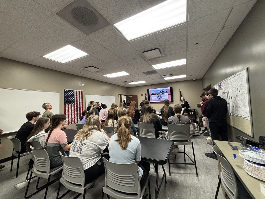 A large group of students sits inside the Andrew County Jail classroom while staff members lead a presentation at the front of the room.