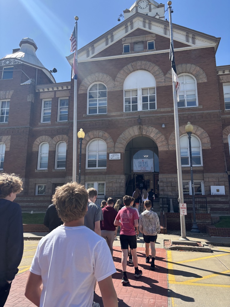 Students walk toward the front entrance of the Andrew County Courthouse on a sunny day in Savannah.