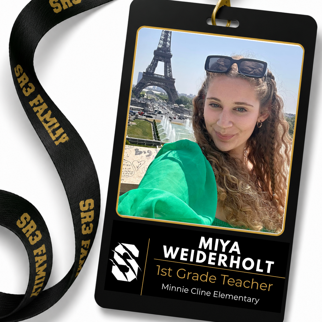 Portrait of new Minnie Cline Elementary first grade teacher Miya Wiederholt smiling in front of the Eiffel Tower.
