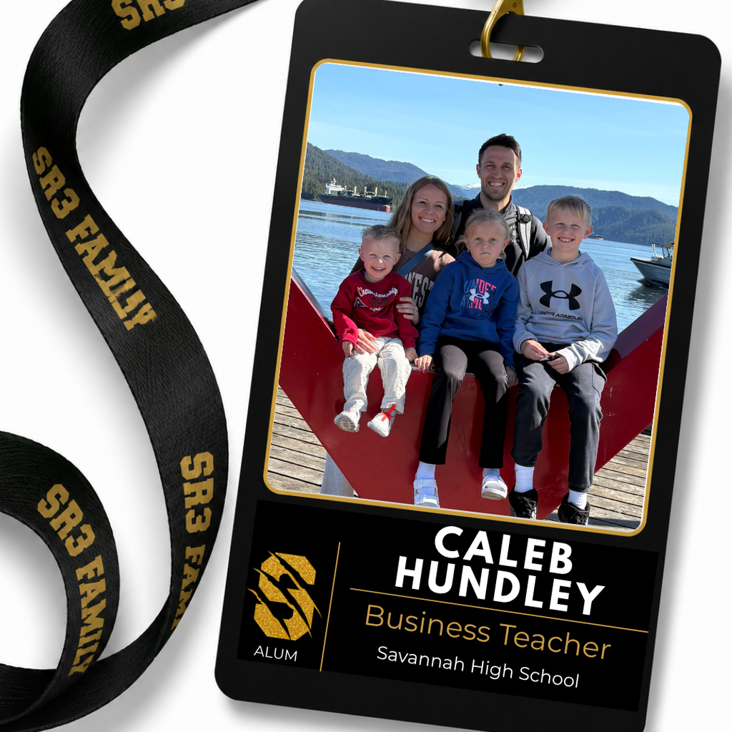 Family photo of returning Savannah High School business teacher and Savannah alum Caleb Hundley with his wife and three children by the waterfront.