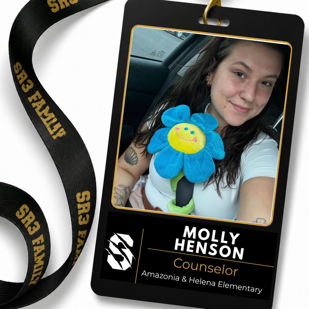 Molly Henson, the new counselor for Amazonia and Helena Elementary, smiles for a selfie while holding a blue flower plush attached to a seatbelt. She is featured on an SR3 staff ID badge graphic.