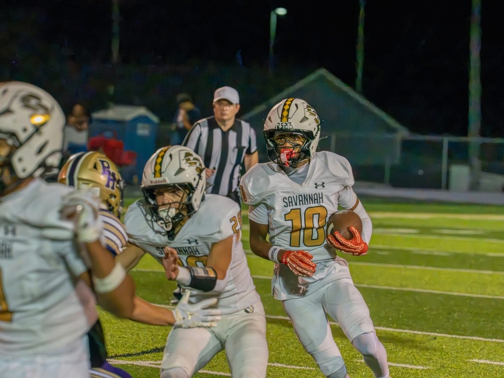 Savannah football player No. 10 carries the ball behind his blockers during Friday night’s game.