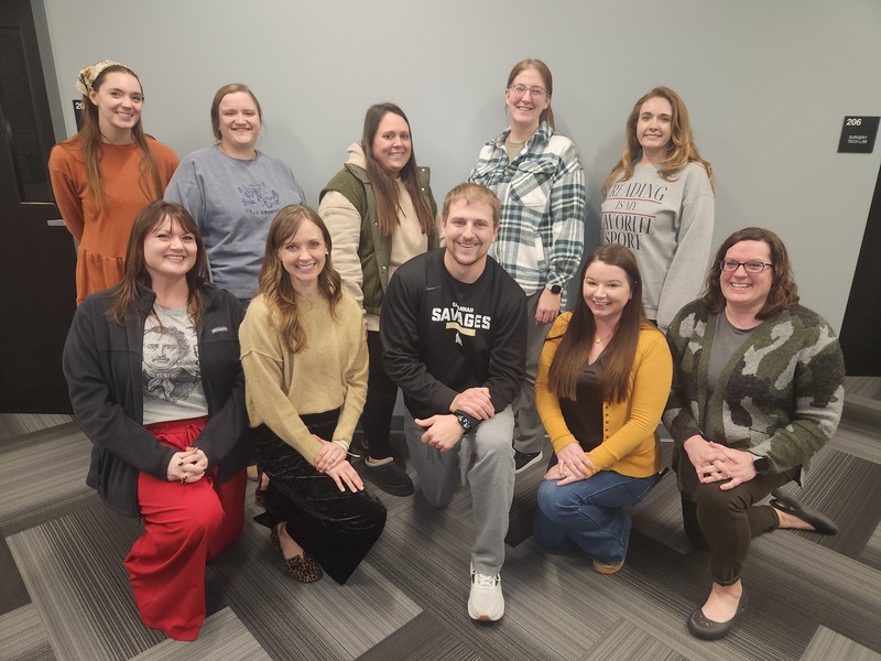 group of 10 teachers smile for a posed picture