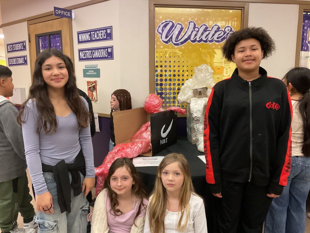 Wilder students smiling infront of their tape art for Big Art Day 2025