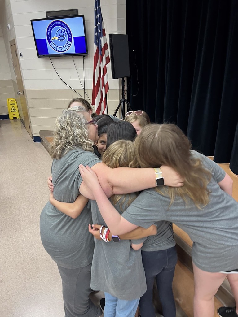 Mrs. Williams hugging her battle of the books students.