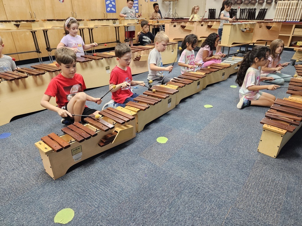 first grade students playing instruments