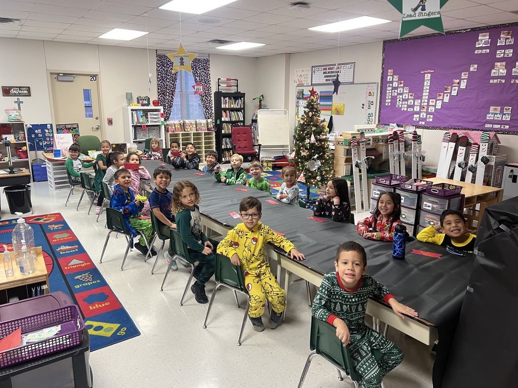 kindergarten students celebrating the holidays in their classroom while wearing their pajamas.