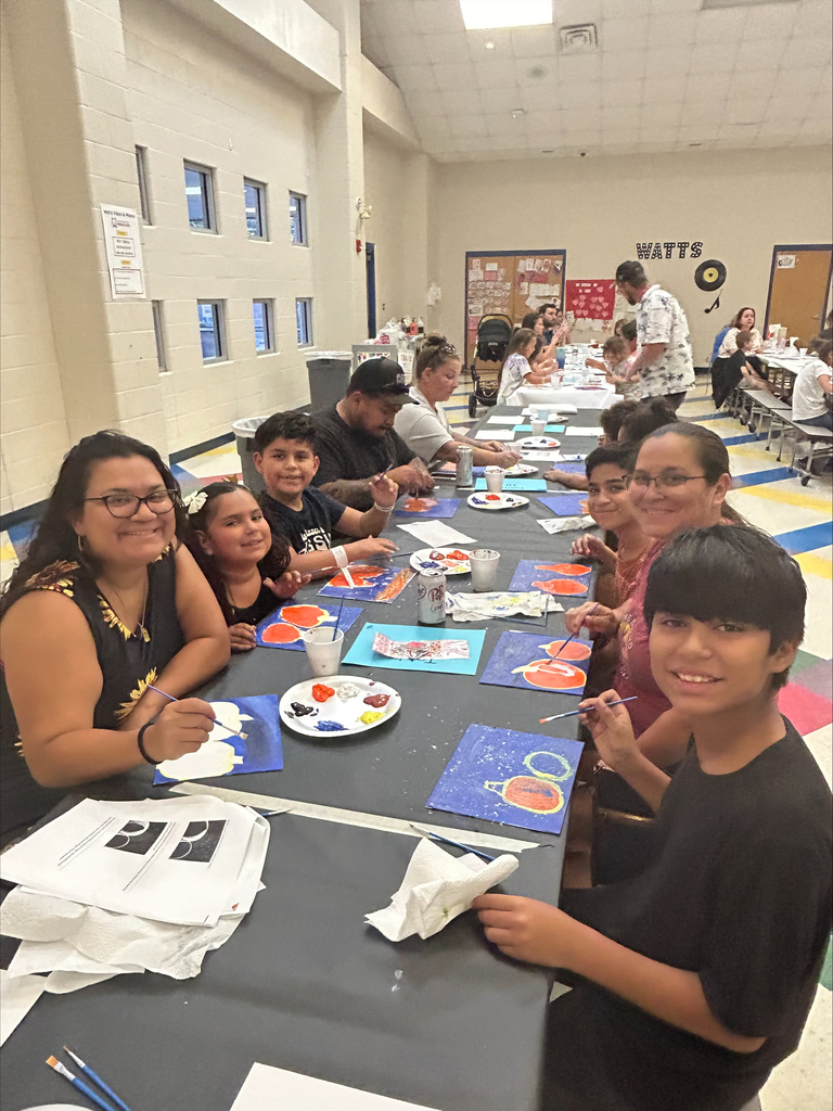 students and their families engaged in a family art night at their elementary school.