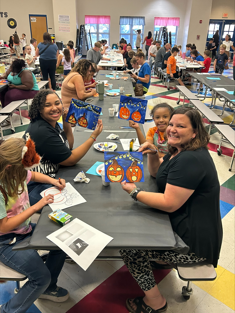 students and their families engaged in a family art night at their elementary school.