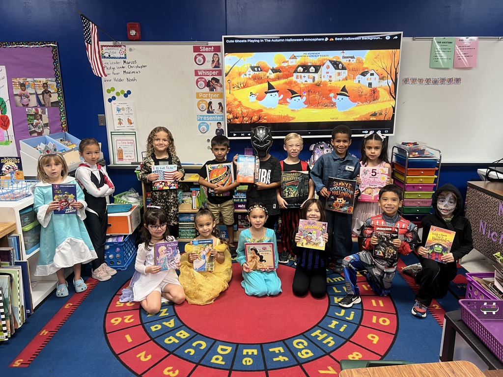 students holding their favorite storybook and dressed as their favorite book character. 