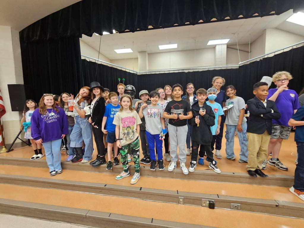 Large group of students posing during lunch.