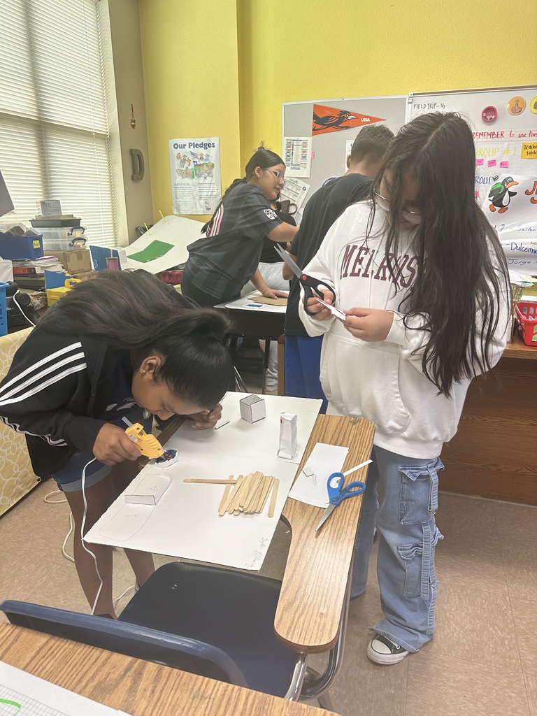Girls hard at work on their geo city project.