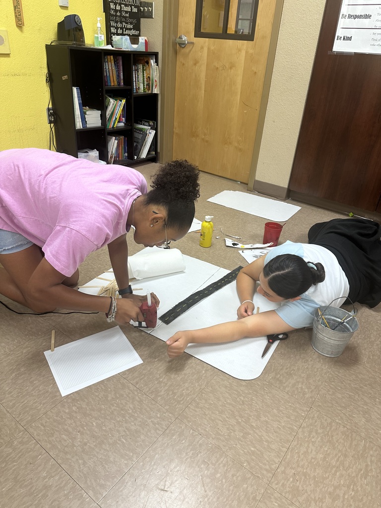 Girls measuring out their geo city project.