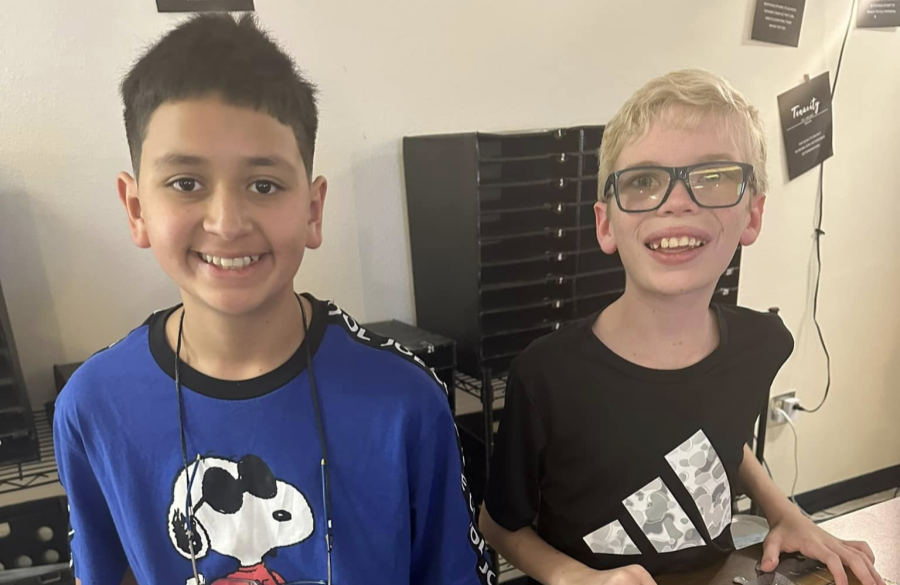 two students posing together in a classroom